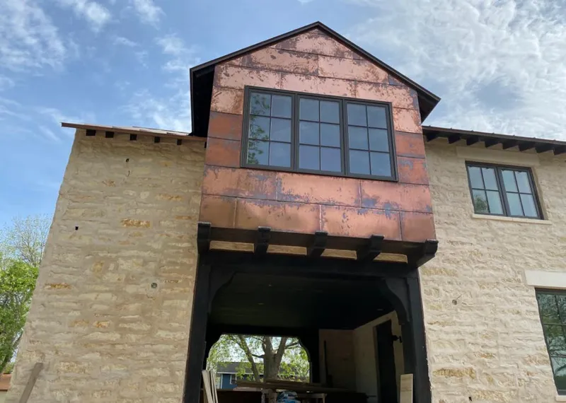 Copper metal panel facade on a stone building for Skylight Installation in Taft