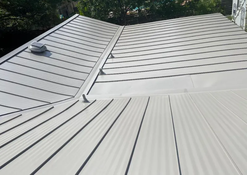 Solar attic fan installed on a metal roof for Roof Ventilation in Taft